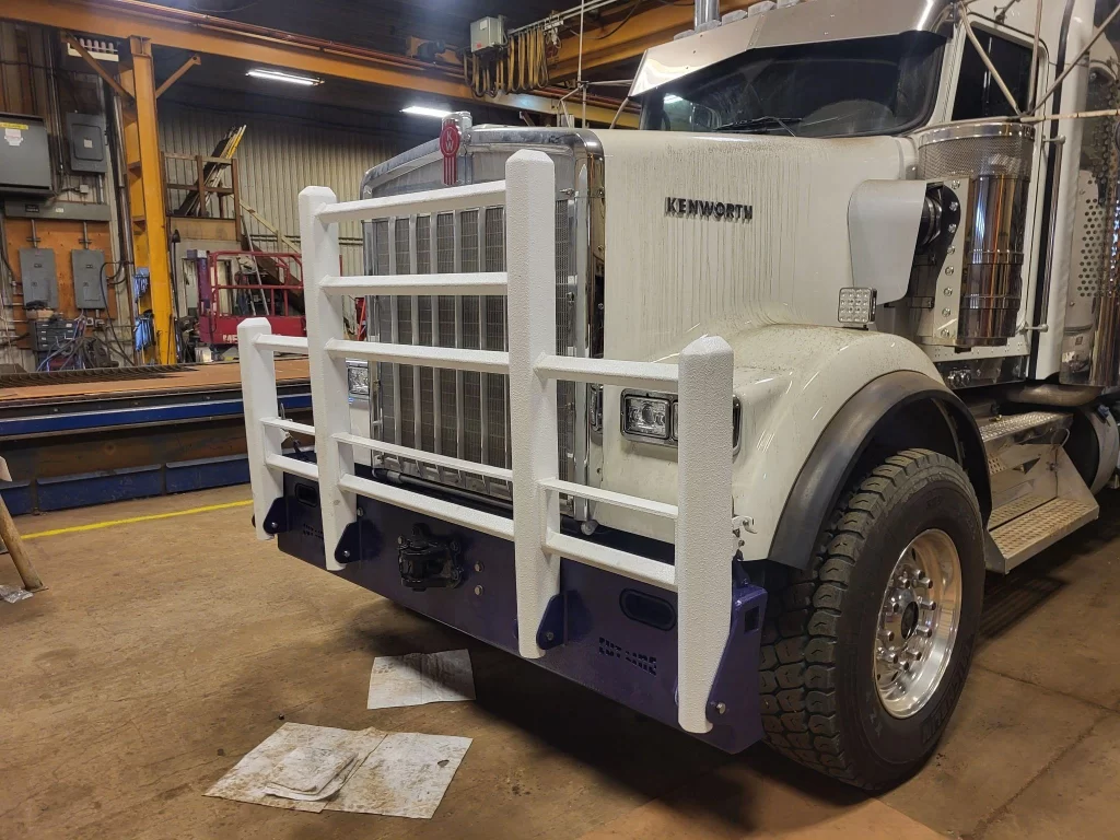 Custom Kenworth T880 Bumper & Rack Fully custom bumper, bush bar, headache rack, rear fenders, cabinets & hydraulic wet tank.